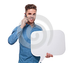 Young casual man with speech bubble speakng on the phone
