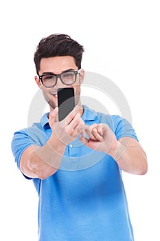 Young casual man taking his picture with a mobile camera phone