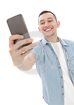 Young casual man taking selfie photo using mobilephone