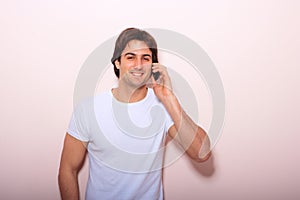 Young casual man talking on the phone