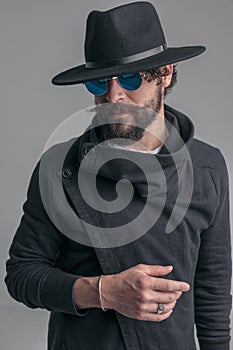 Young casual man with tough look is wearing sunglasses