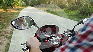 Young casual man traveler driving motorbike on tropical sunny road. slow motion. 1920x1080