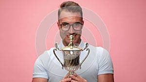 young casual man wearing polo shirt on pink background