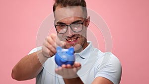 Young casual man wearing polo shirt on pink background