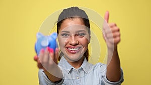 young casual woman in denim blue shirt on yellow background