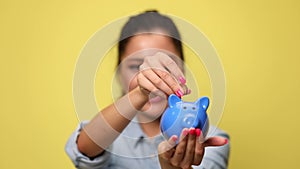 young casual woman in denim blue shirt on yellow background