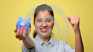 young casual woman in denim blue shirt on yellow background