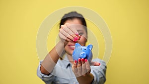 young casual woman in denim blue shirt on yellow background