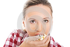 Young casual woman eating popcorn.