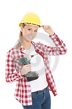 Young casual woman holding drill and wearing safety helmet.