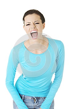 Young casual woman screaming with anger