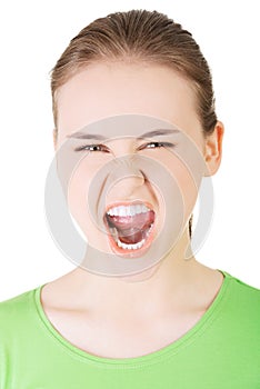 Young casual woman screaming with anger