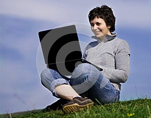 Young casual woman working on laptop