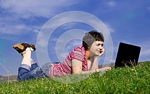 Young casual woman working on laptop