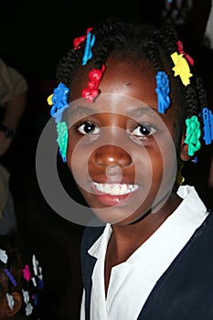 Young Catholic school girl is all smiles in rural village clinic.