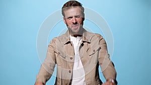 young caual man on blue background