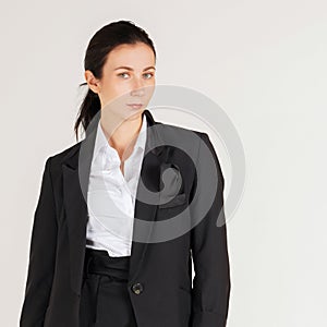 Young cauasian business woman in white shirt and  black suit standing in a white photography scene. Portrait on white background photo