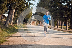 Young caucasian adult man jogging in beautiful region of italy