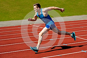 Young caucasian athlete sprinting on track