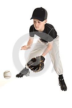 Young caucasian baseball player catching a grounder