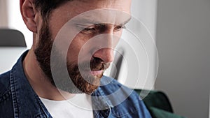 Young caucasian bearded freelancer man working on computer at home.