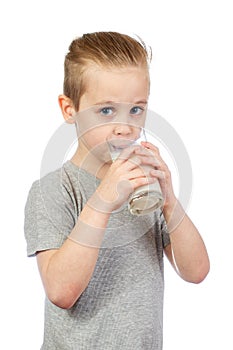 Young caucasian boy drinks milk
