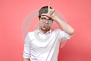 Young caucasian boy in glasses showing looser sign