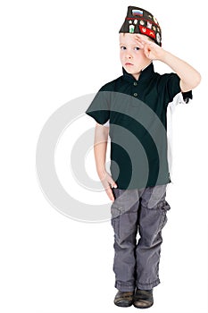 Young caucasian boy saluting in respect looking front on playing dressups