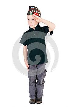 Young caucasian boy saluting in respect looking left playing dressups