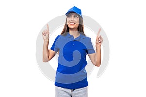 young caucasian brunette advertiser woman in blank blue t-shirt and cap showing thumbs up