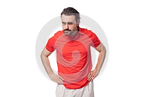 young caucasian brunette man with beard dressed in casual red t-shirt on studio background with copy space