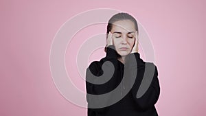 Young caucasian brunette woman in sweater suffering from headache or Migraines