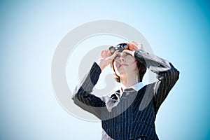 Young caucasian business lady with binoculars