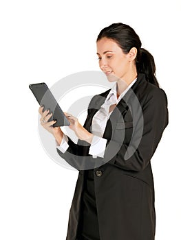 Young caucasian business woman in black suit with a smile, typing on a tablet computer. Portrait on white background with studio