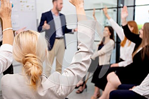 Young caucasian businessman asking opinion and brainstorm of employee while raise hand up for participation together.