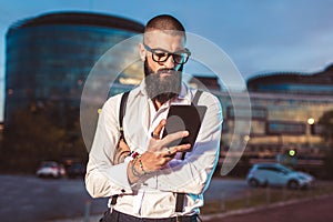 Young caucasian businessman holding a digital tablet