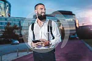 Young caucasian businessman holding a digital tablet outdoor