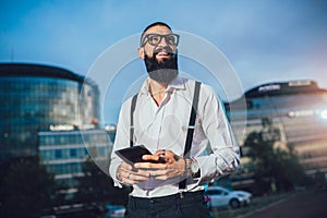 Young caucasian businessman holding a digital tablet outdoor