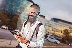 Young caucasian businessman holding a tablet