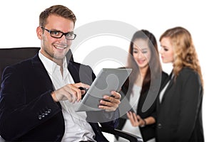 Young caucasian businessman holding a tablet pc, his staff on th