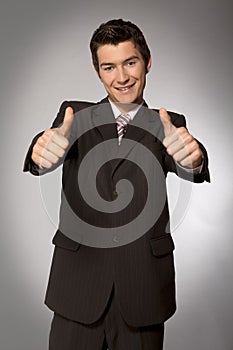 Young caucasian businessman showing ok gesture