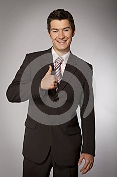 Young caucasian businessman showing ok gesture