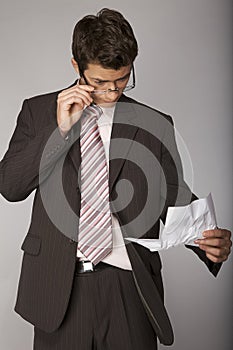 Young caucasian businessman stern on document