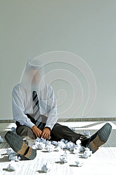 young caucasian businessman with trash bin on his head