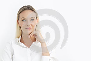 Young Caucasian businesswoman with blue eyes looking at camera with white background