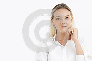 Young Caucasian businesswoman with blue eyes looking at camera with white background