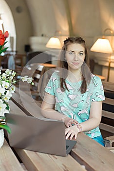 Young caucasian businesswoman in cafe sitting at the table with thoughtful stare.