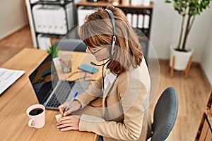 Young caucasian call center agent woman smiling happy working at the office