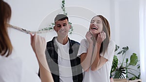 Young caucasian couple gets keys from their new apartment from real-estate agent and getting so excited. Footage from