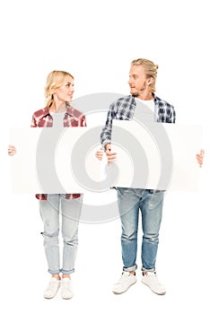 young caucasian couple holding blank banners in hands